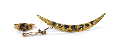 Lot 1015 - A gold sapphire set crescent brooch