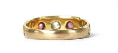 Lot 1032 - A gold diamond and ruby three stone ring