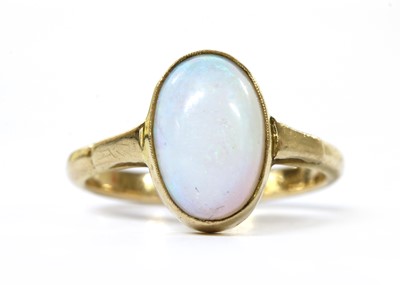 Lot 1058 - A gold single stone opal ring