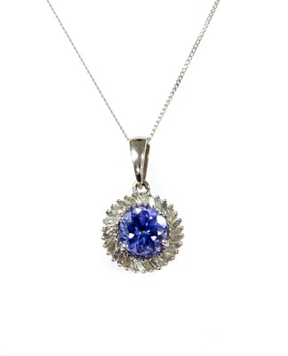 Lot 307 - A white gold tanzanite and diamond cluster pendant