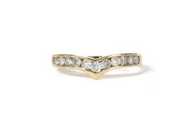 Lot 140 - A gold diamond wishbone-shaped half eternity ring