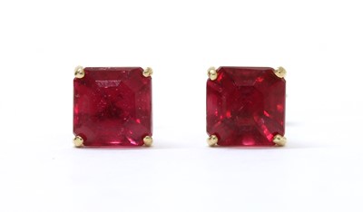 Lot 234 - A pair of gold single stone fracture filled ruby stud earrings