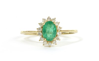 Lot 159 - A gold emerald and diamond cluster ring