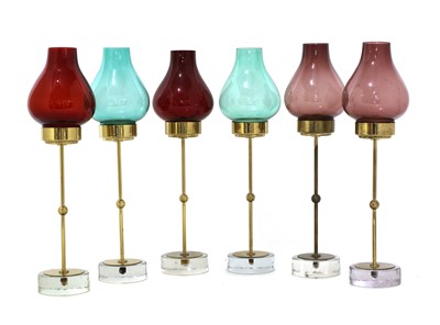 Lot 608 - A set of six brass and glass candlesticks