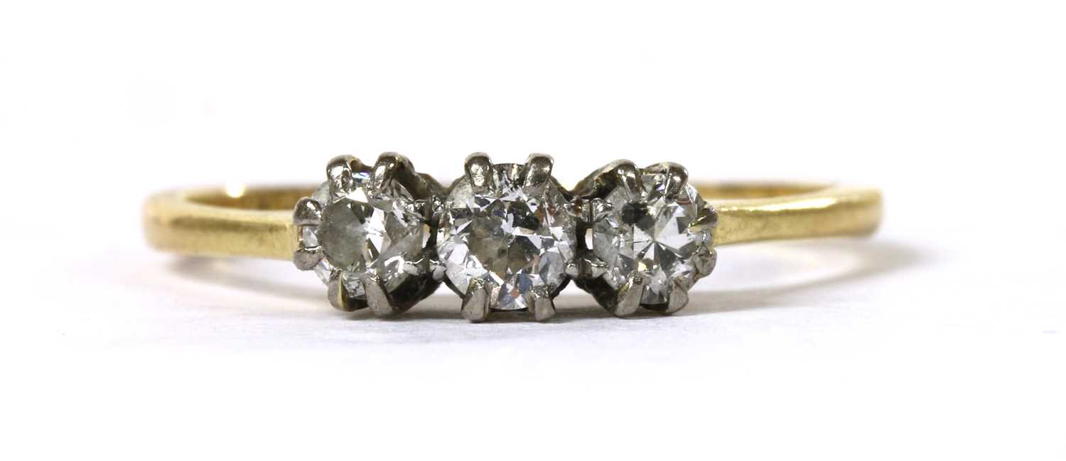 Lot 99 - A gold three stone diamond ring