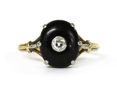 Lot 1066 - A gold diamond and onyx ring