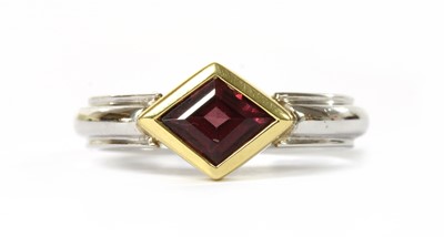 Lot 1248 - A two colour gold single stone garnet ring