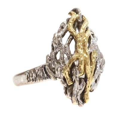 Lot 289 - An 18ct yellow and white gold diagonal lozenge shaped domed head ring, c.1970