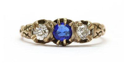 Lot 1033 - A gold garnet-and-glass doublet and diamond three stone ring