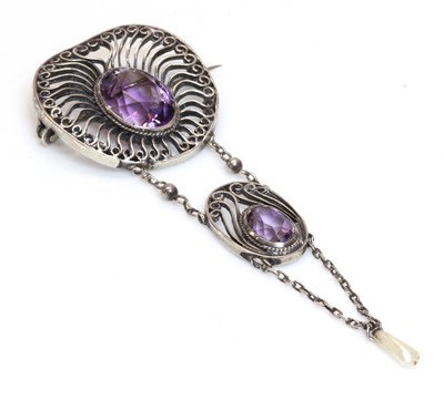 Lot 1055 - A silver Arts and Crafts amethyst and dog tooth pearl brooch, c.1910