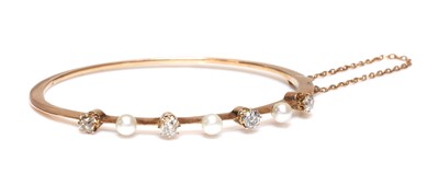 Lot 142 - A former Austro-Hungarian pearl and diamond hinged bangle, c.1890