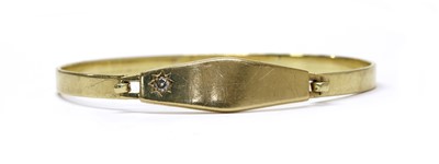 Lot 123 - A gold diamond set identity bangle