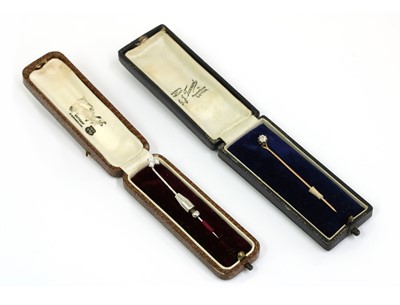 Lot 38 - Two diamond set stick pins