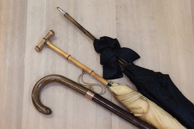Lot 67 - Two parasols and an umbrella stick
