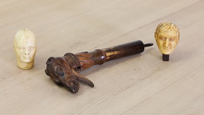 Lot 300 - A carved wooden walking stick or parasol handle