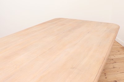 Lot 24 - A large limed oak dining table