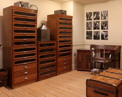 Lot 48 - An oak and glazed haberdasher's cabinet