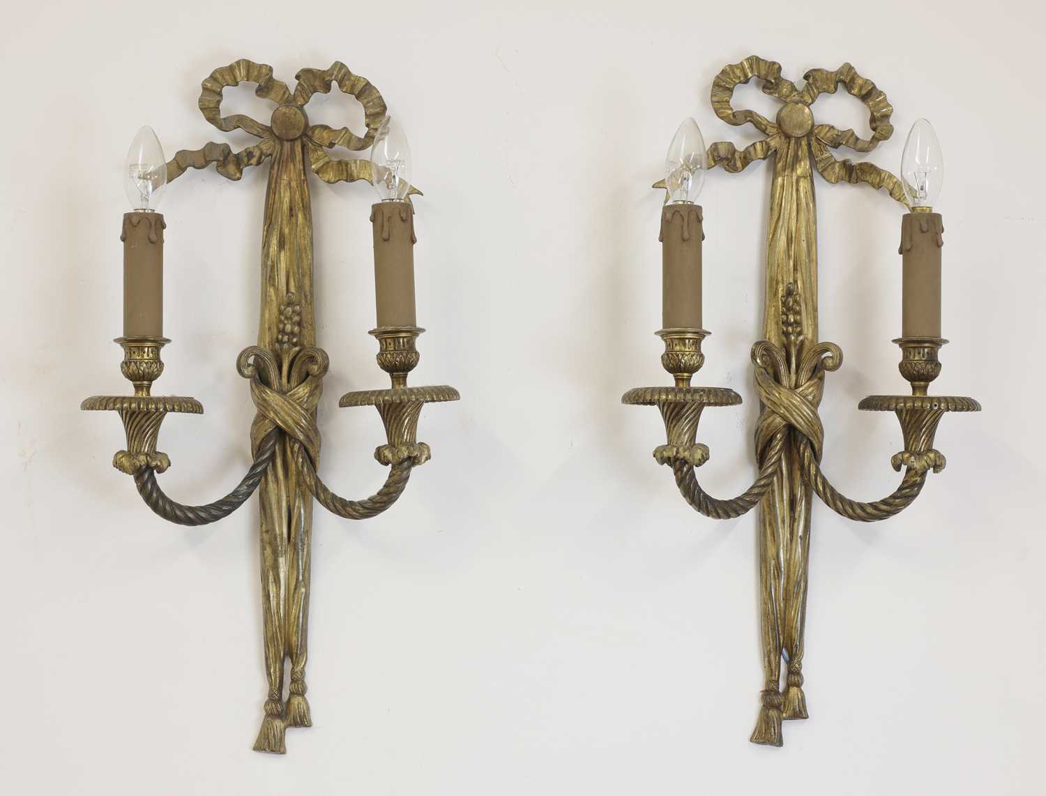 Lot 57 - A pair of gilt-bronze twin-branch wall lights