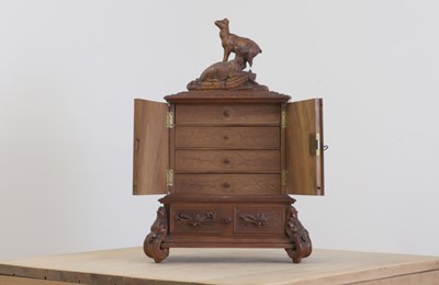 Lot 150 - A Black Forest carved wooden table cabinet