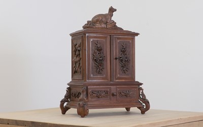 Lot 150 - A Black Forest carved wooden table cabinet