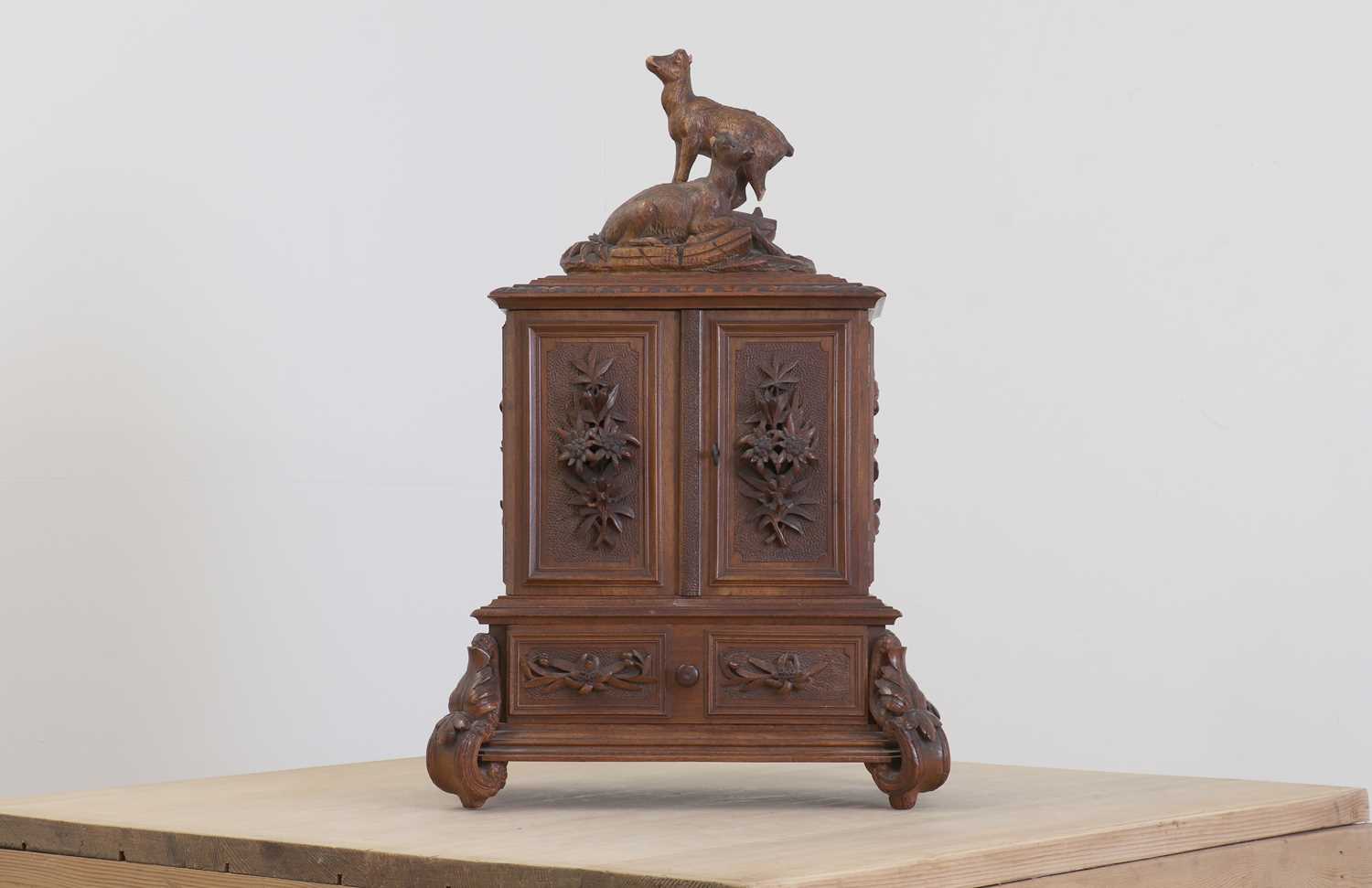 Lot 150 - A Black Forest carved wooden table cabinet