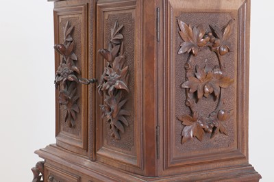 Lot 150 - A Black Forest carved wooden table cabinet