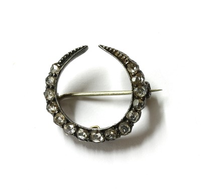 Lot 7 - A silver and gold, diamond crescent brooch