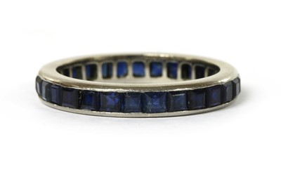 Lot 1067 - A white gold sapphire full eternity ring