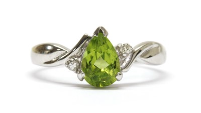 Lot 263 - A white gold peridot and diamond ring