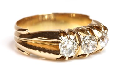 Lot 106 - An Edwardian rose gold three stone diamond ring, c.1905
