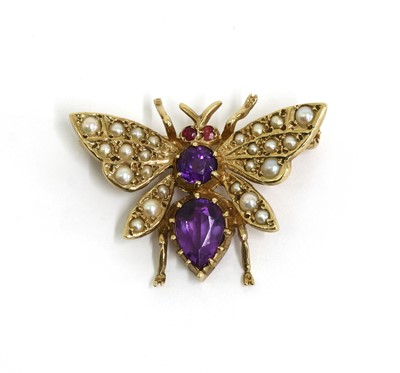 Lot 318 - A 9ct gold amethyst, ruby and seed pearl set butterfly brooch