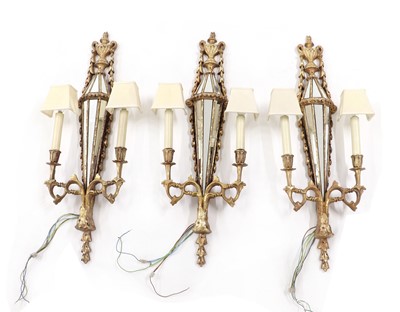 Lot 296 - A set of three gilt-composite and glass wall lights