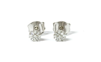 Lot 1133 - A pair of white gold diamond cluster stud earrings