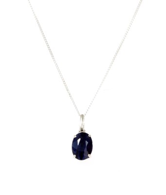 Lot 1210 - A white gold single stone sapphire pendant