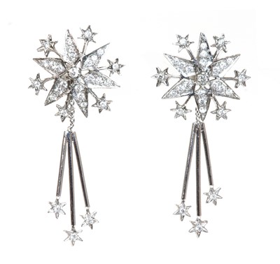 Lot 309 - A pair of 18ct white gold diamond set star burst drop earrings