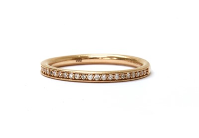 Lot 1114 - A 14ct rose gold diamond half eternity ring