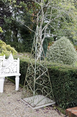 Lot 825 - A set of four iron scrolling obelisk plant frames