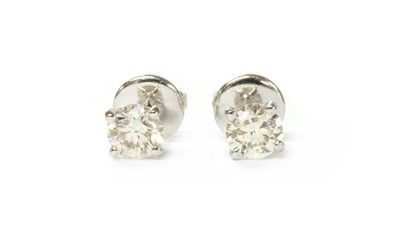 Lot 1120 - A pair of 18ct white gold single stone diamond stud earrings