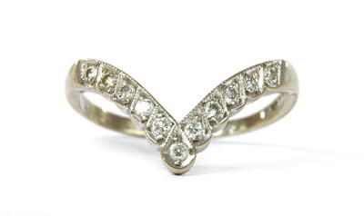 Lot 1127 - An 18ct white gold diamond set wishbone ring
