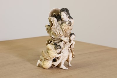 Lot 170 - A Japanese solid carved ivory family group