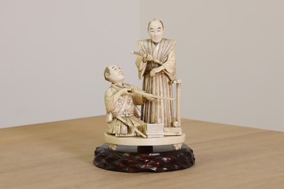 Lot 169 - A Japanese sectional carved ivory okimono