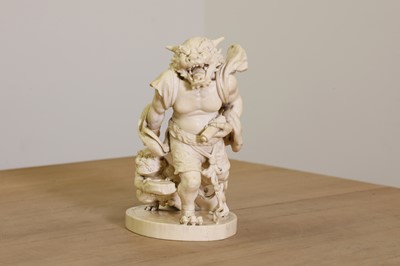 Lot 154 - A Japanese solid carved ivory oni okimono