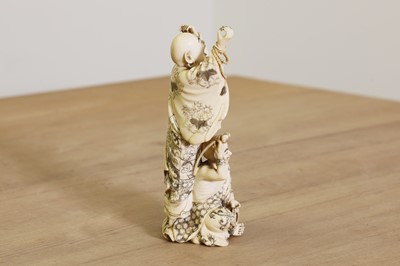 Lot 166 - A Japanese carved ivory okimono