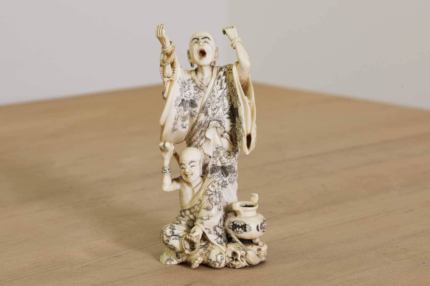 Lot 166 - A Japanese carved ivory okimono