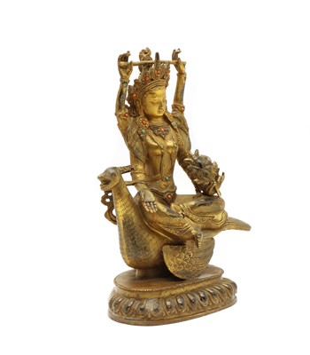 Lot 74 - A Sino-Tibetan bronze buddha
