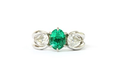 Lot 1183 - A white gold emerald and diamond three stone ring