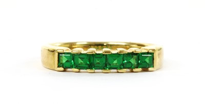 Lot 1198 - A gold six stone tsavorite garnet ring