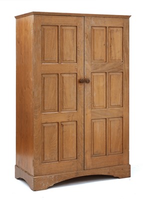 Lot 229 - A Cotswold School walnut wardrobe
