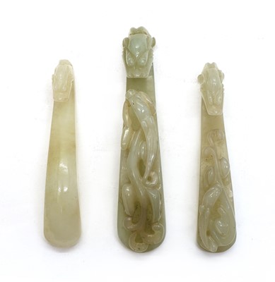 Lot 129 - A collection of three Chinese jade belt hooks