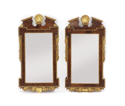 Lot 514 - A pair of George II-style walnut and parcel-gilt pier mirrors